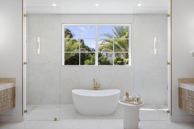 bathroom featuring vanity and shower with separate bathtub