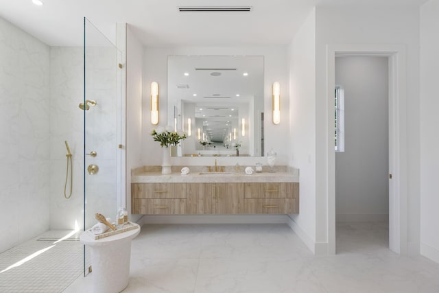 bathroom with vanity and tiled shower