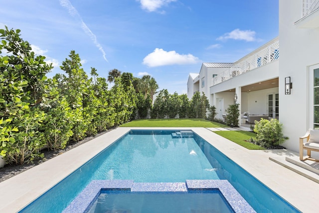 view of swimming pool featuring an in ground hot tub, a patio, and a yard