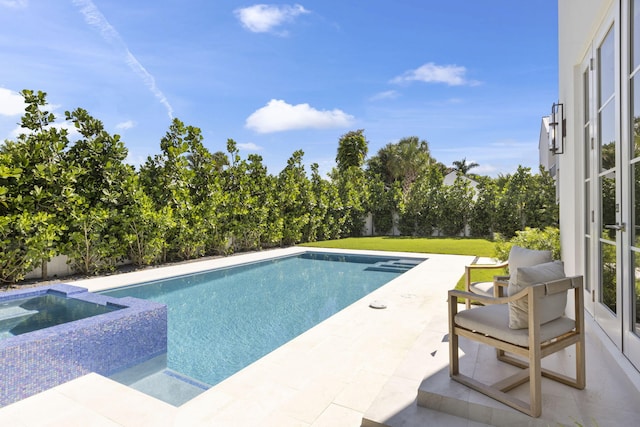 view of pool featuring an in ground hot tub, a patio area, and a lawn