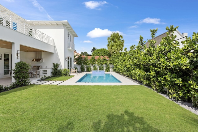 view of swimming pool with a patio, a lawn, and area for grilling