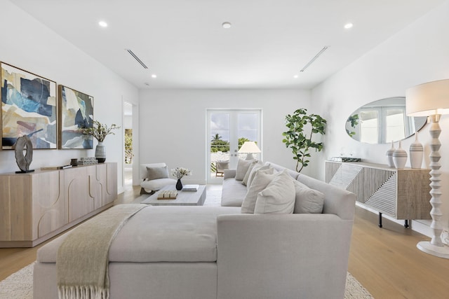 living room featuring light hardwood / wood-style flooring and french doors