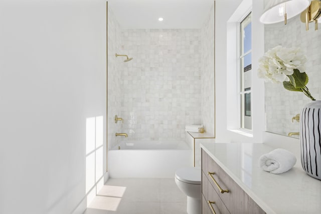 full bathroom featuring tiled shower / bath combo, toilet, tile patterned floors, and vanity