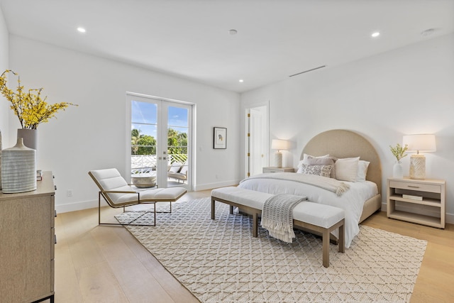 bedroom with access to outside, french doors, and light wood-type flooring