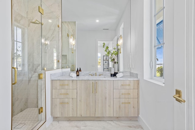 bathroom with an enclosed shower and vanity