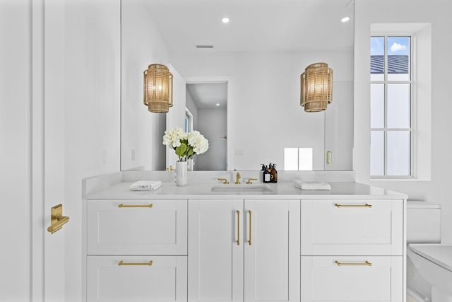 bathroom featuring toilet and vanity