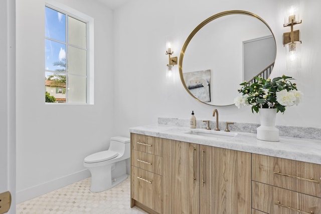 bathroom with toilet and vanity