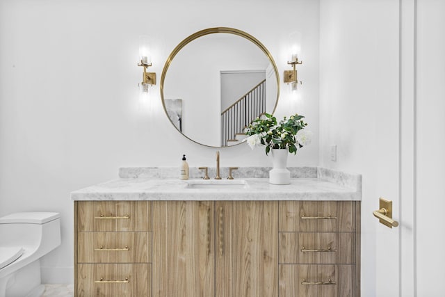 bathroom featuring toilet and vanity