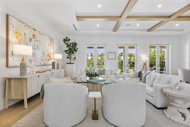 living room with coffered ceiling, light wood-type flooring, beamed ceiling, and french doors