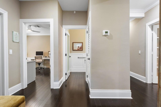 corridor featuring dark hardwood / wood-style flooring and ornamental molding