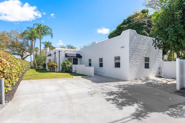 view of side of property with a lawn