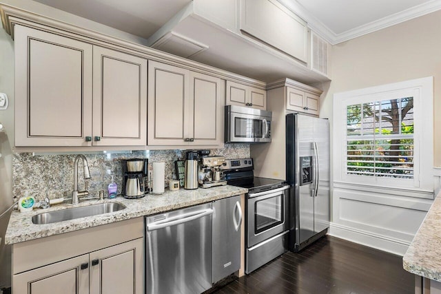 kitchen featuring cream cabinets, appliances with stainless steel finishes, dark wood-type flooring, sink, and light stone counters