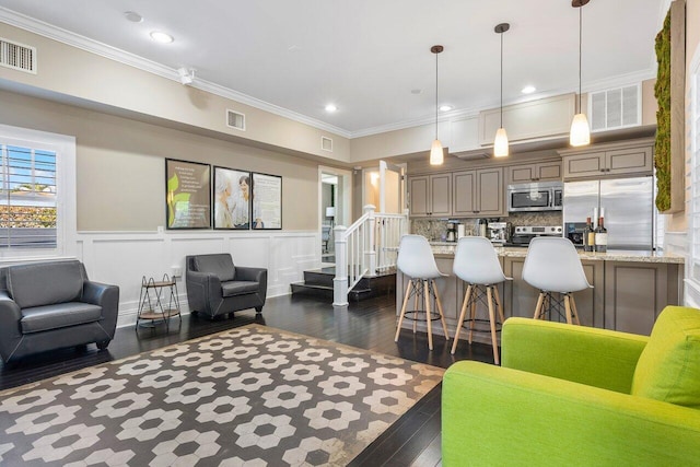 living room featuring ornamental molding and dark hardwood / wood-style flooring