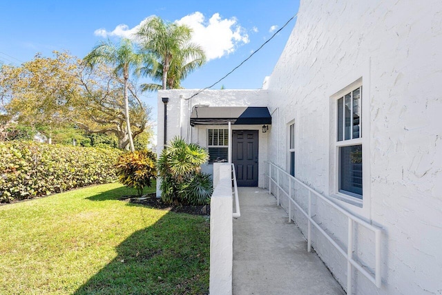 doorway to property featuring a yard