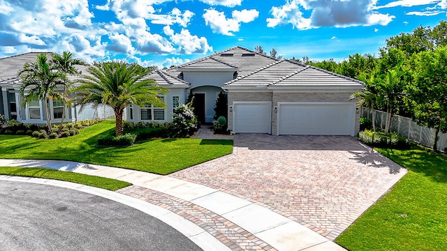 view of front of home with a front lawn and a garage