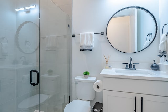 bathroom featuring walk in shower, vanity, and toilet