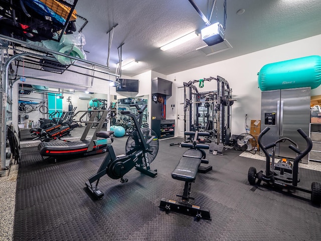 exercise room featuring a textured ceiling