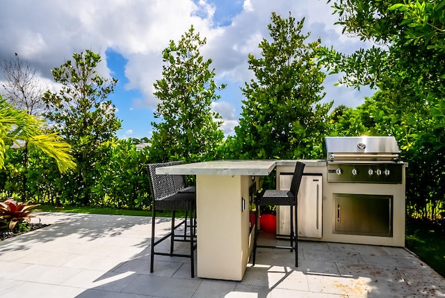 view of patio with a grill and exterior kitchen