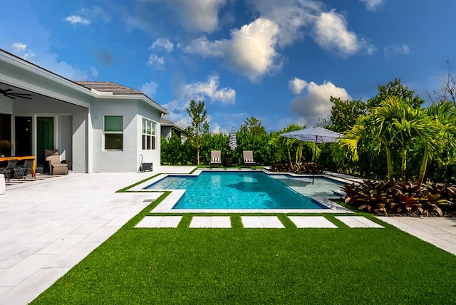 view of swimming pool featuring a yard and a patio area