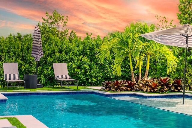 view of pool at dusk