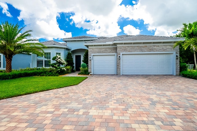 view of front of home with a garage and a front lawn