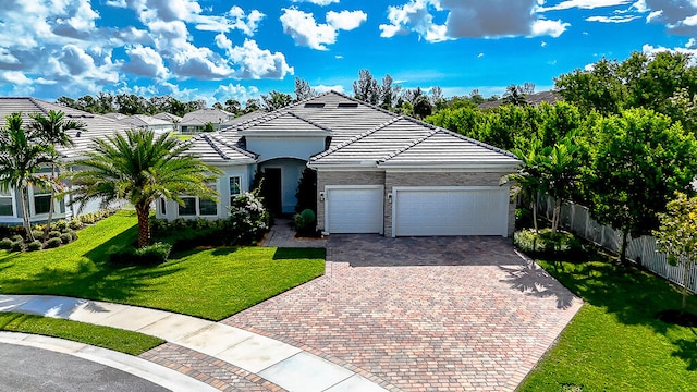 view of front of house featuring a garage and a front lawn