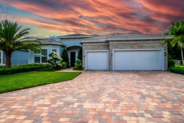 view of front facade with a lawn and a garage