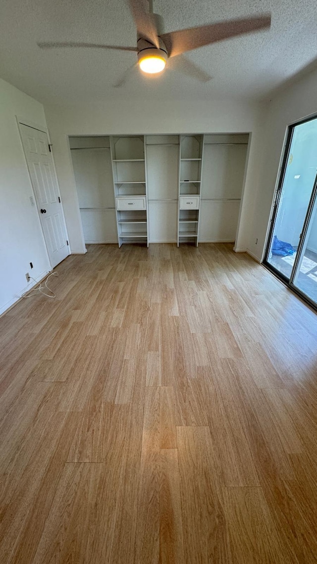 unfurnished bedroom with light wood-type flooring, a textured ceiling, access to outside, and ceiling fan