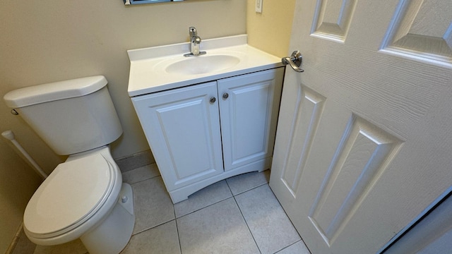 bathroom featuring tile patterned flooring, vanity, and toilet