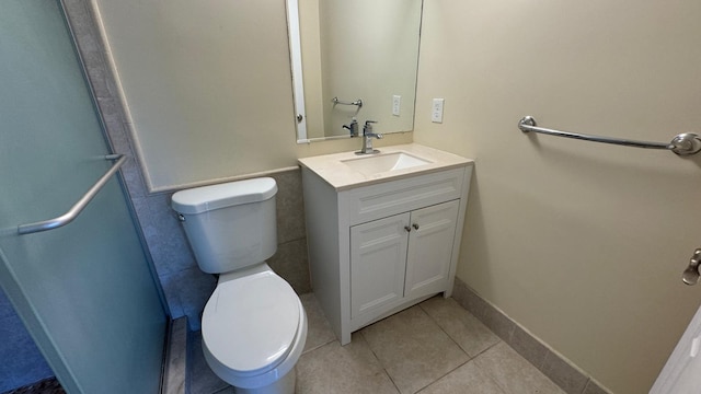 bathroom featuring vanity, toilet, and tile patterned floors