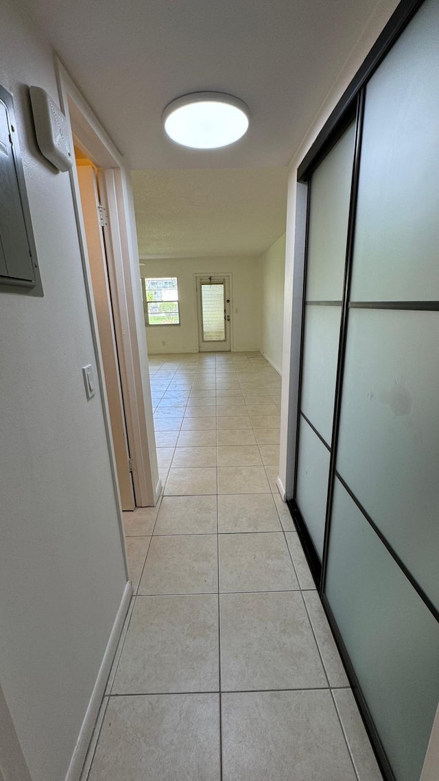 hallway featuring light tile patterned floors