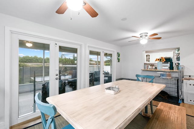 dining space featuring hardwood / wood-style floors, ceiling fan, and french doors