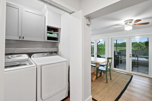 laundry area featuring cabinets, washing machine and clothes dryer, light hardwood / wood-style flooring, ceiling fan, and french doors