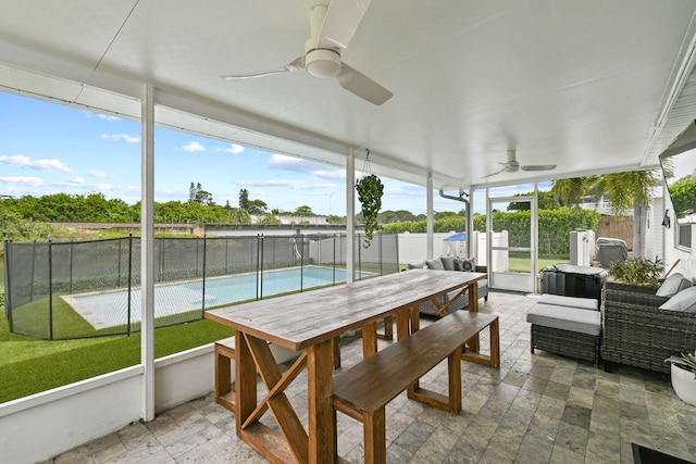 sunroom / solarium featuring ceiling fan