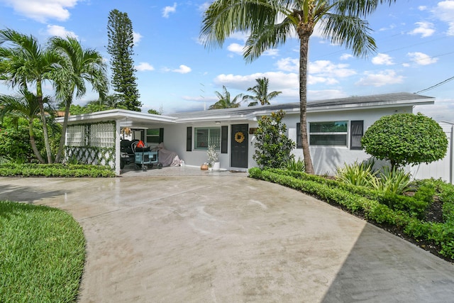 ranch-style house featuring a carport