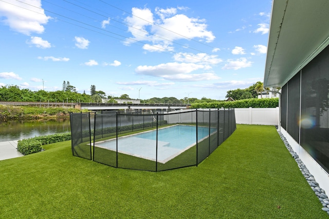 view of pool featuring a lawn and a water view