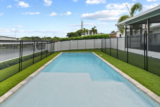 view of pool with a yard