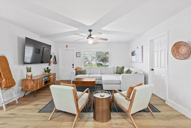 living room with light hardwood / wood-style floors and ceiling fan