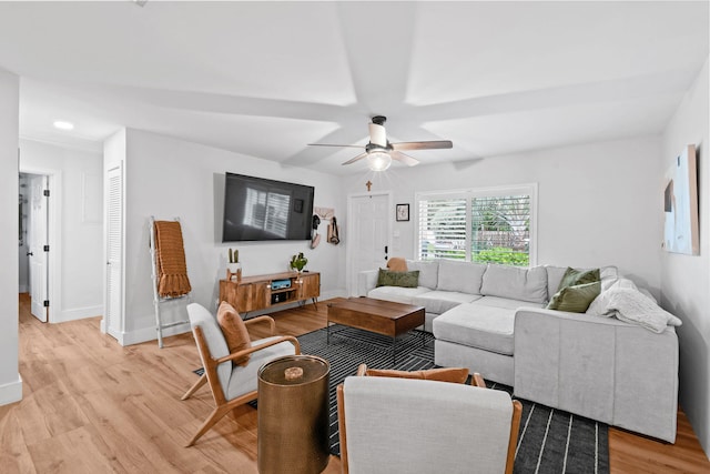 living room featuring light wood-type flooring and ceiling fan