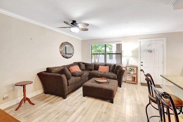 living room with light wood-type flooring, ornamental molding, and ceiling fan