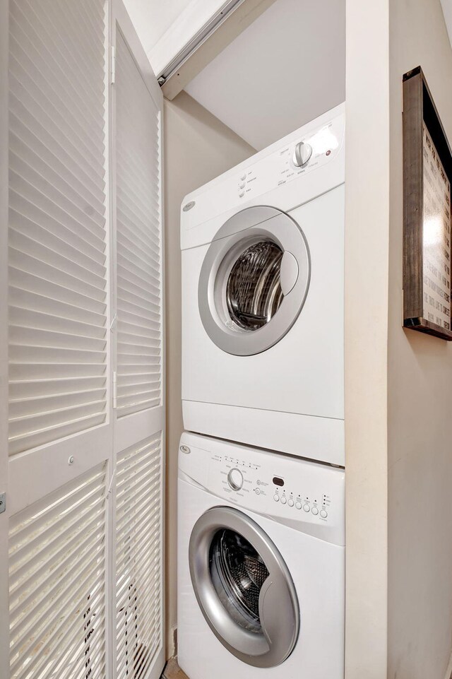 laundry area featuring stacked washer / dryer