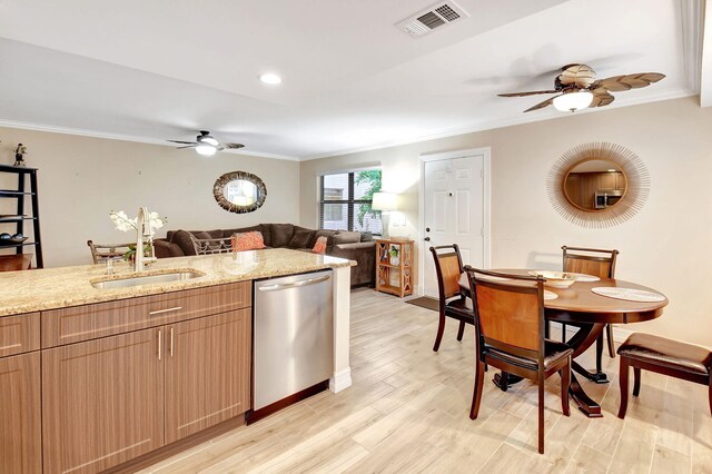 kitchen featuring light hardwood / wood-style flooring, light stone counters, sink, ceiling fan, and stainless steel dishwasher