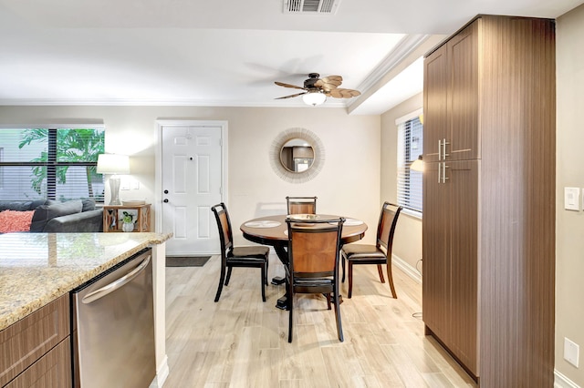 dining room featuring ceiling fan, plenty of natural light, crown molding, and light hardwood / wood-style flooring