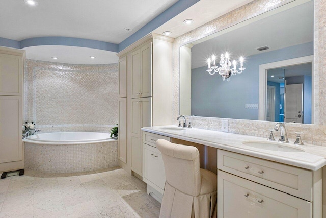 bathroom featuring tiled bath and vanity