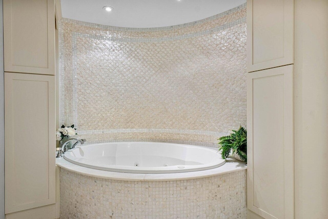 bathroom featuring a relaxing tiled tub