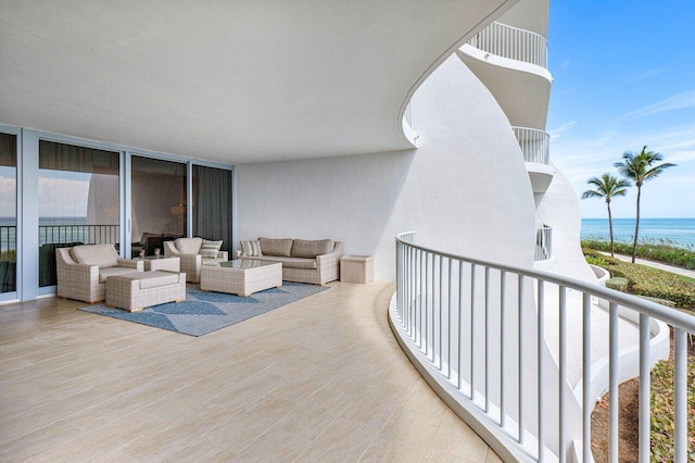 balcony with outdoor lounge area and a water view