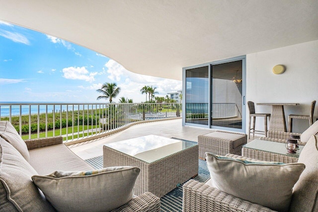 balcony featuring a water view and outdoor lounge area