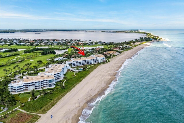 birds eye view of property featuring a beach view and a water view