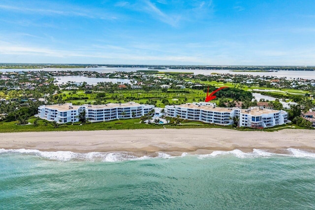 birds eye view of property featuring a beach view and a water view