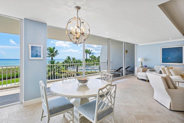 dining area with a water view, a wealth of natural light, light parquet floors, and crown molding